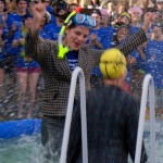 students jump into cold water for chairty