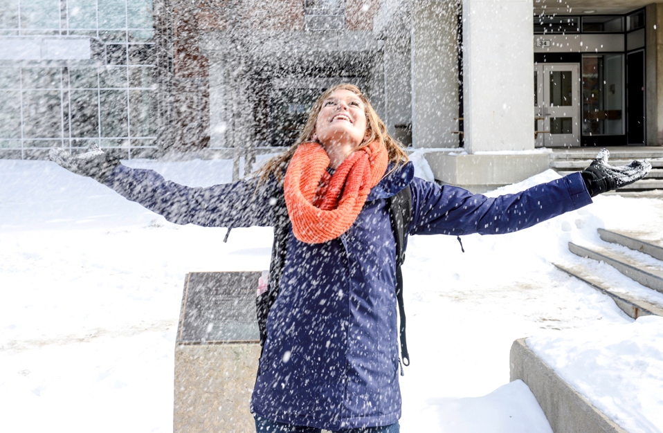 student joyful under snowfall