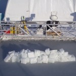 ice blocks sit atop sea ice created in an outdoor lab