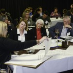 Alumni discuss things at a table