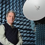 Lotfallah Shafai standing in front of a satelite.