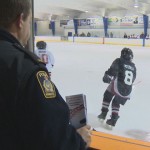 police officer watching a hockey game