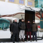 Students Yin Zheng, Wei Zou, and Rafael Vieira Leal with instructor Phillipe Perron stand in front of their warming hut entry, "Mirror Cloaking"