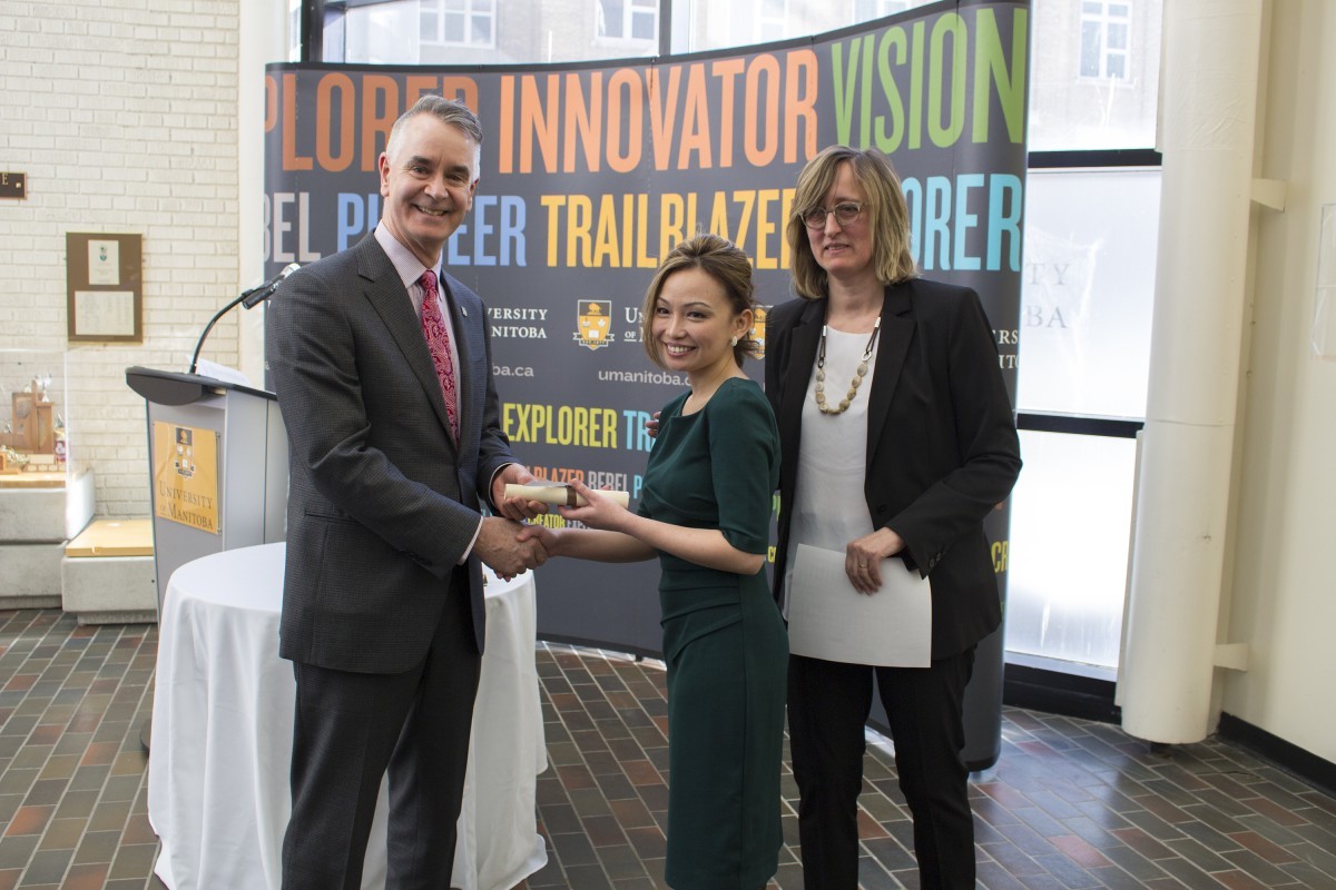 Dr. Chona Lim receives her diploma from Dr. Jeff Sisler and Dr. Martina Reslerova