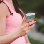 anonymous girl holds a cell phone