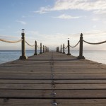 a dock extends into the lake's horizon