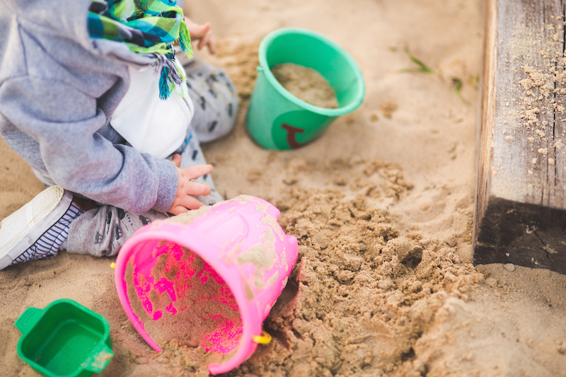 child playing in sand