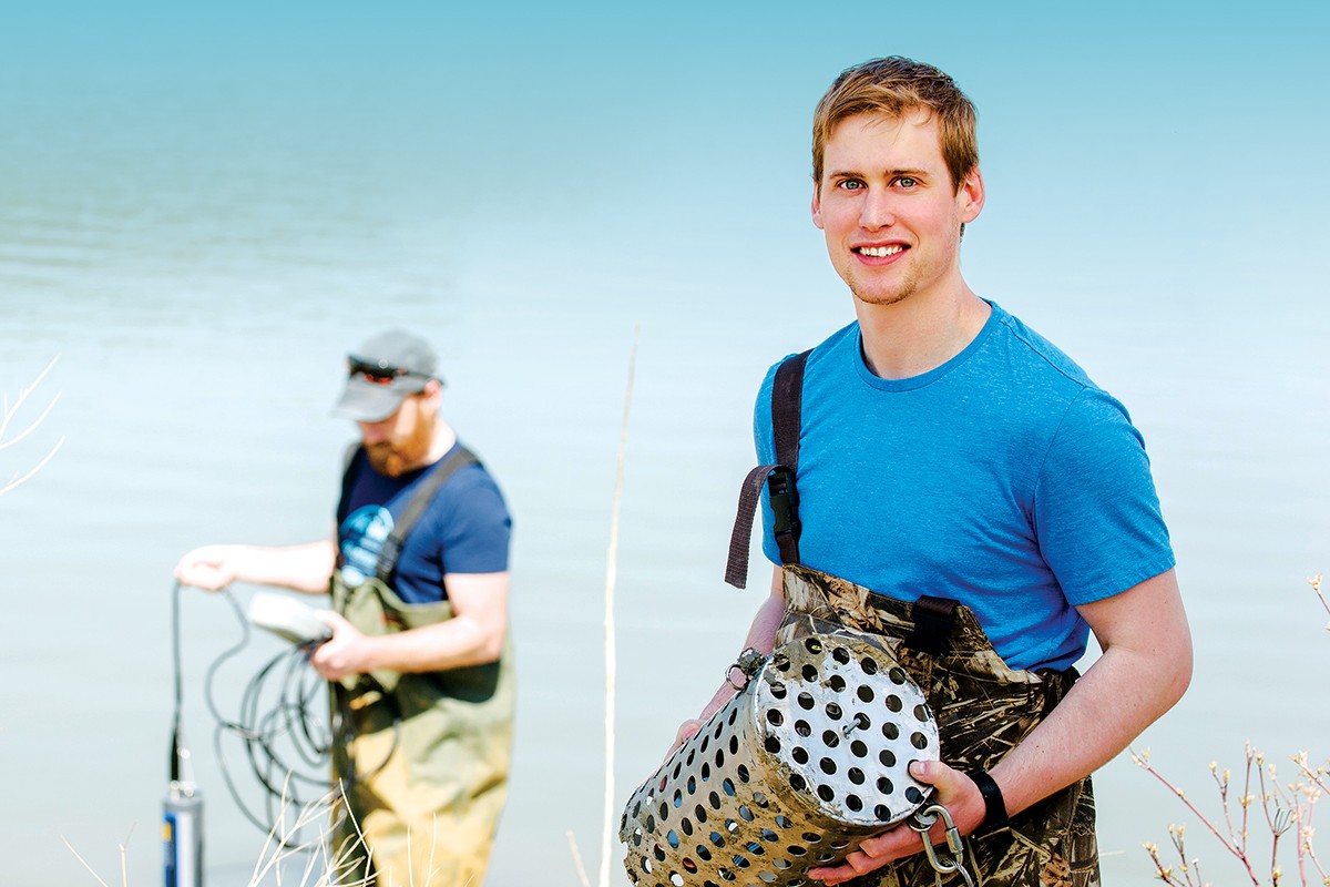 Jonathan Challis, PhD student in Chemistry, collecting water samples. // Photo by Ian McCausland