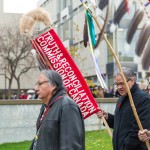 Carl Stone leading the ceremonial procession across the Fort Garry Campus