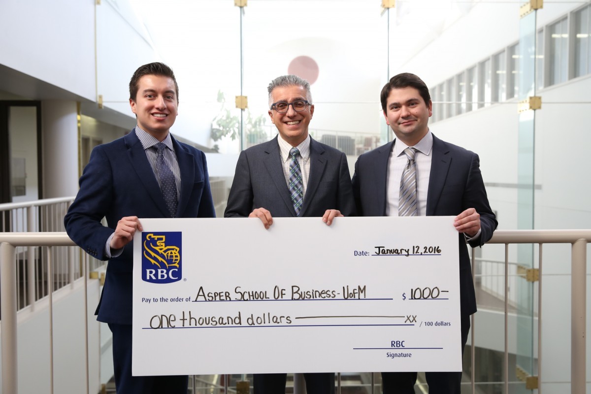 Edward Acuna presents a donation of $1,000 to the Asper School of Business