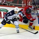Winnipeg Jets defenseman Mark Stuart checks Washington Capitals forward Nicklas Backstrom. // Photo: clyde, Flickr