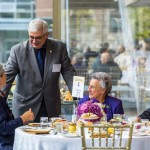 President Barnard speaking with alumni at the Chancellors Tea