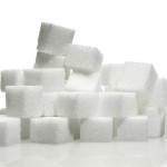 sugar cubes stacked and standing before a white background