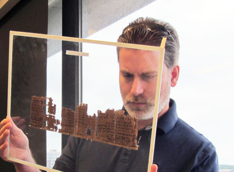 Michael Sampson examines a papyri in teh University of Michigan's collection // Photo: Monica Tsuneishi