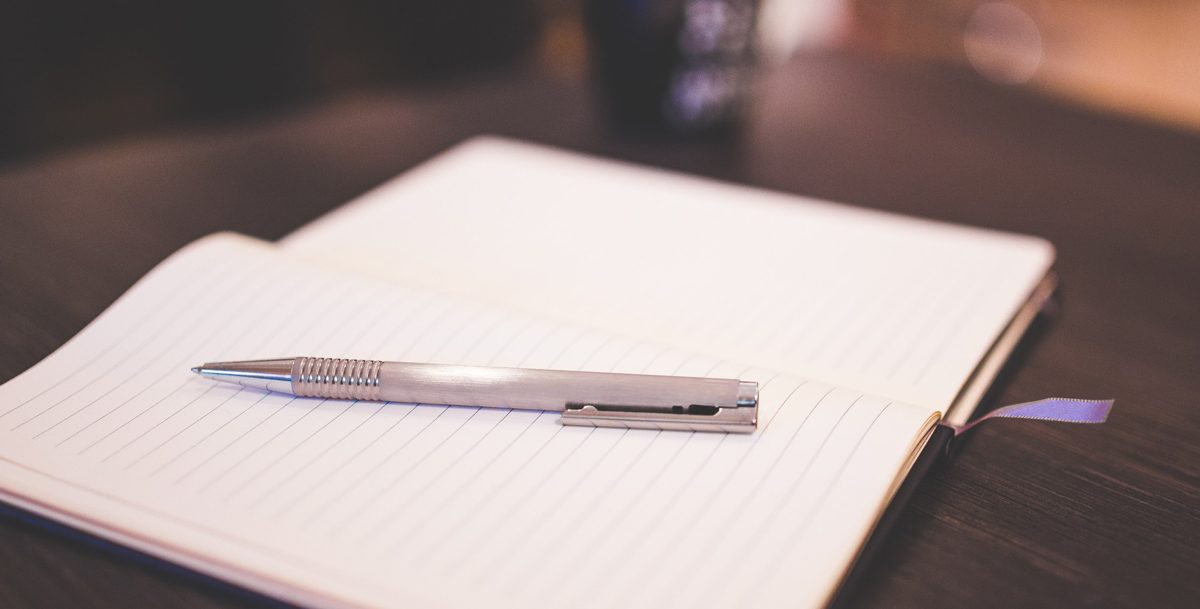 pen resting on a notpad