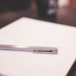 pen resting on a notpad