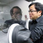 Feiyue Wang uses a glove box in his lab, allowing him to work with samples sensitive to oxygen. // Photo by Kaitlin Vitt