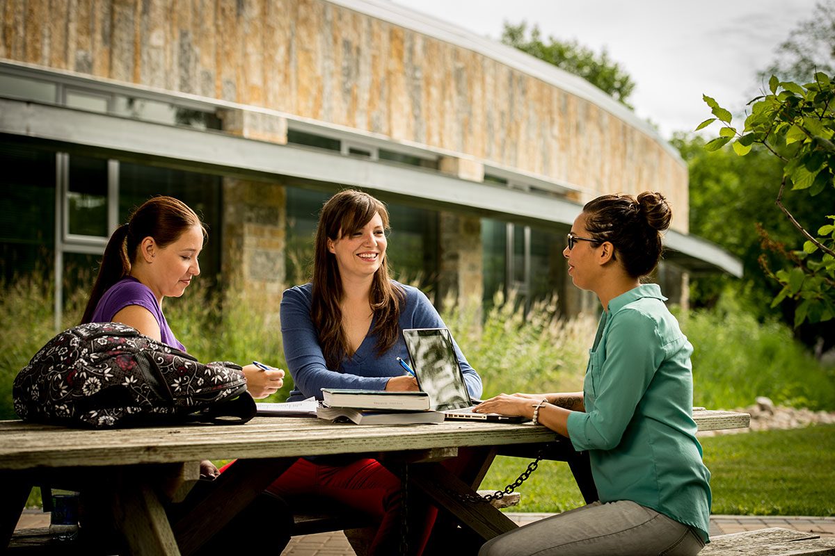 Students outside Migizii Agamik - Bald Eagle Lodge.