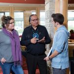 Indigenous students speak with Carl Stone in Migizii Agamik