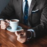 man in suit with coffee
