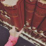 Old books being removed from a shelf. Photo by @poli_abramov
