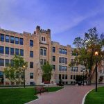 Buller building with rough limestone cladding under the evening golden hour light.