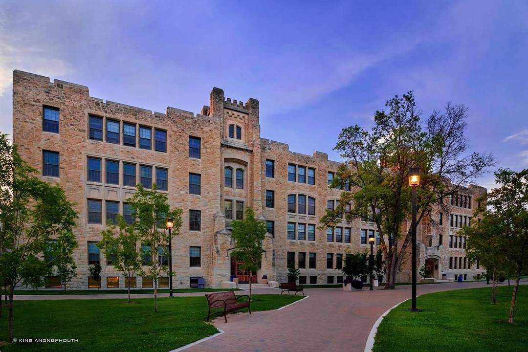 Buller building with rough limestone cladding under the evening golden hour light.