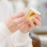 Patient holding a prescription bottle.