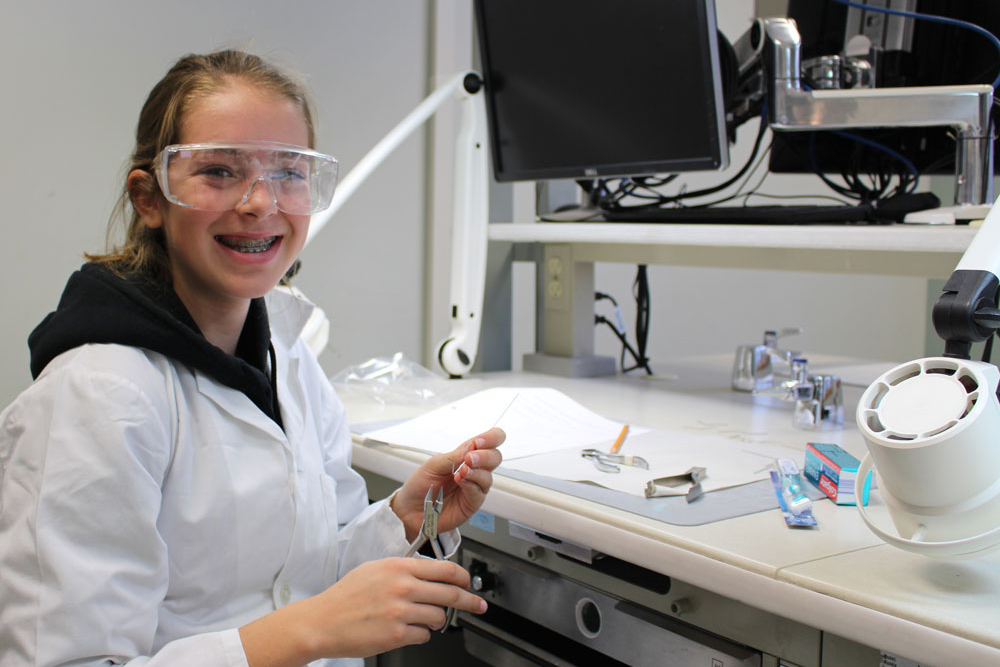 Take Our Kids to Work Day - a student using using orthodontic tools