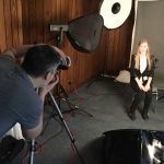A student poses in front of a photographer for a free headshot at the Career Fair