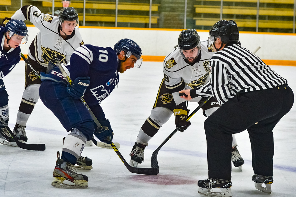 Bison captain, Brett Stovin faces off against Mount Royal’s David Stephens, October 27, 2017 // Photo: Jeff & Tara Miller