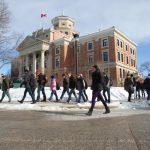 Students walk by the Administration Building