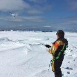 Madison Harasyn flying a drone over ice.