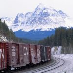 CNR train driving through Canadian Rockies. // Image from Canadian National Railway Company