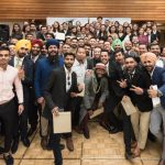 International students cheer as they celebrate the completion of their studies.