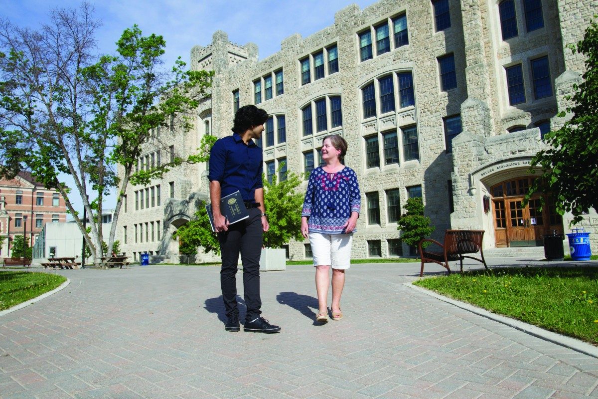 Career mentor and mentee walking in front of Buller building