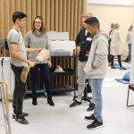 students interacting with a researcher in a lab
