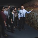 Pourang Irani (right) with students inspecting a spatio-temporal dataset on a large screen display.