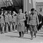 Adolf Hitler and Benito Mussolini walking in front of saluting military during Hitler's visit to Venice, Italy in 1934. // Image from Wikimedia Commons