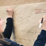 Student writing a comment during a public engagement event
