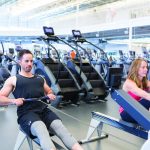 Two people exercising in a gym