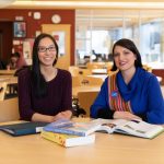 Two graduate students studying