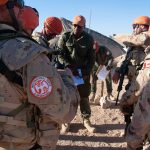 Canadian Armed Forces personnel being briefed by a Fijian colleague on a task they are to perform.