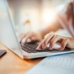 Person typing on laptop computer.