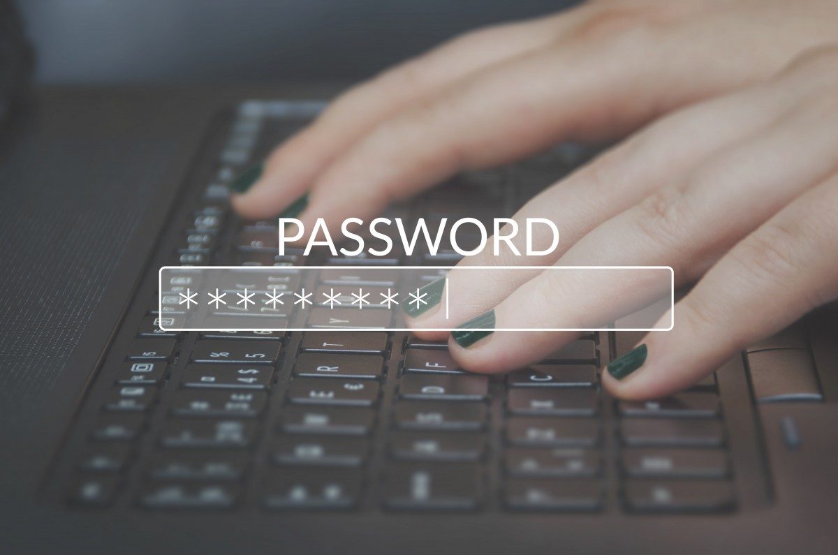 hands at keyboard typing with a password login image laid over top