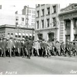 Special police marching west down Portage from Main Street during June 10, 2019 riot. // Winnipeg Tribune Photograph Collection at U of M Archives and Special Collections