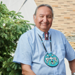 Carl Stone sits outside of Migizii Agamik - Bald Eagle Lodge