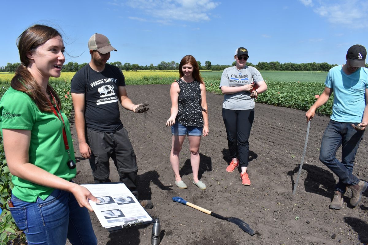Kristen MacMillan with students in field