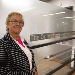 Dr. Marion Alexander in front of the newly-named Dr. Marion Alexander Centre