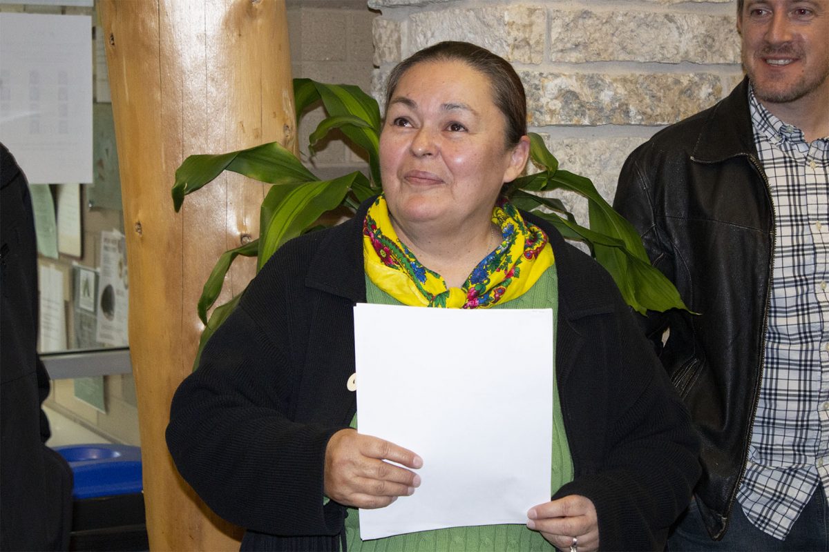 Victoria McIntosh smiles as her art is unveiled.